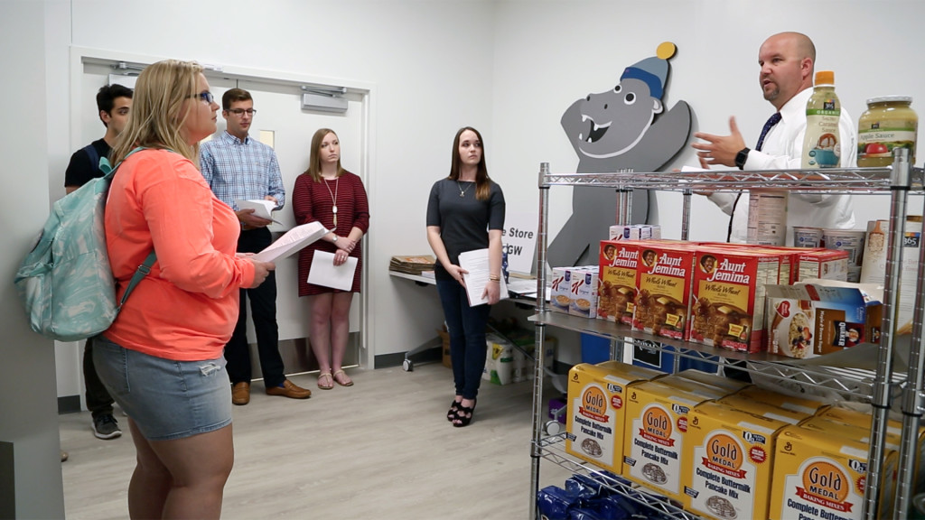 George Washington University students are introduced to the school’s food pantry, called “The Store.” Image still from Washington Post.