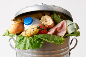 Foods like banana, bread, milk, in a trash can