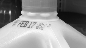 Milk jug zoomed in on food expiration date label