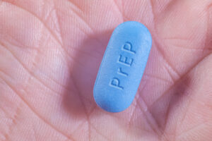 Hand holding a PrEP pill