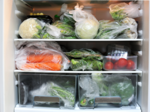 Inside of a fridge filled with bagged produce