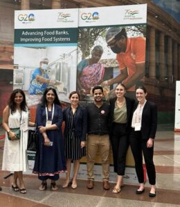 FLPC staff and partners standing in front of signs at the Global Food Security Summit in Dehli, India