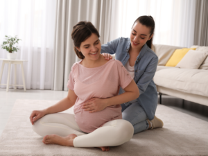 A doula helping a pregnant woman.